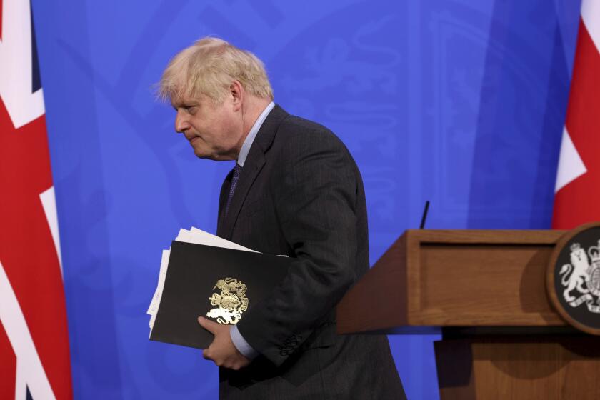 Britain's Prime Minister Boris Johnson attends a media briefing in Downing Street, London, Monday, June 14, 2021. Johnson has confirmed that the next planned relaxation of coronavirus restrictions in England will be delayed by four weeks until July 19 as a result of the spread of the delta variant. In a press briefing Monday, Johnson said he is “confident that we won’t need more than four weeks” as millions more people get fully vaccinated against the virus, which could save thousands of lives. (Jonathan Buckmaster/Pool Photo via AP)