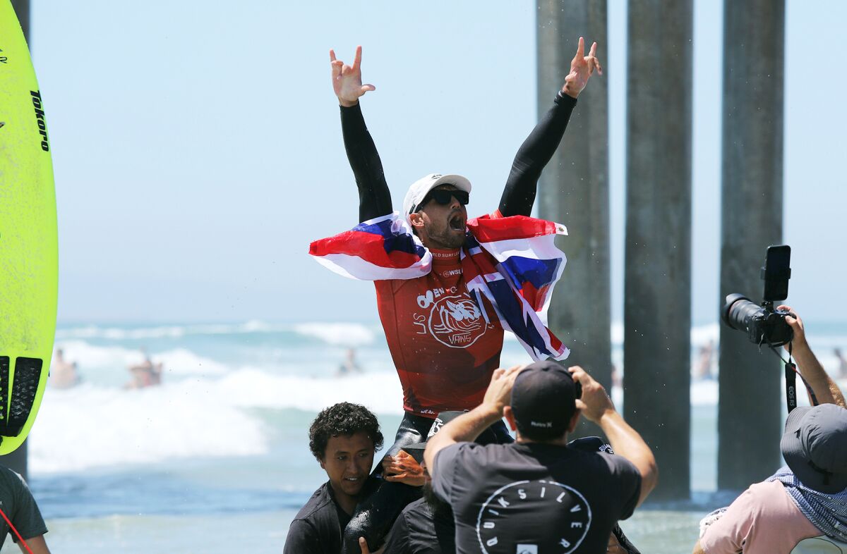 Zeke Lau of Hawaii celebrates winning the men's title at the U.S. Open of Surfing in Huntington Beach on Sunday.