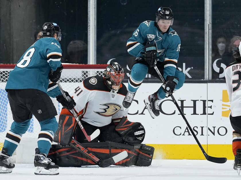 San Jose Sharks center Ryan Donato (16) leaps out of the way as Anaheim Ducks goaltender Anthony Stolarz (41) makes a save during the second period of an NHL hockey game, Monday, April 12, 2021, in San Jose, Calif. (AP Photo/Tony Avelar)