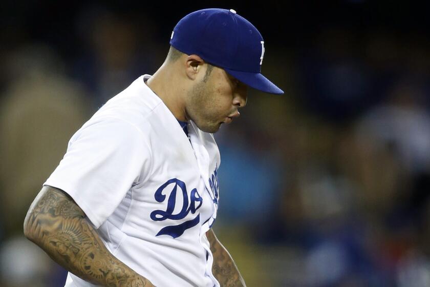 Former Dodgers reliever Sergio Santos reacts after giving up a two-run home run to Colorado's Nolan Arenado on May 16.