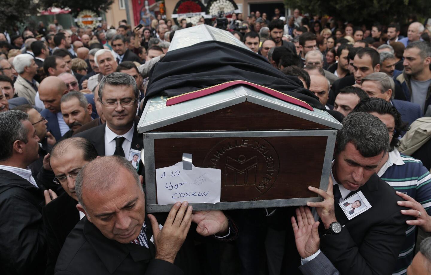 People carry coffin of the Uygar Coskun, who was killed the previous day in a twin blast in Ankara, during a funeral ceremony in Ankara, Turkey.