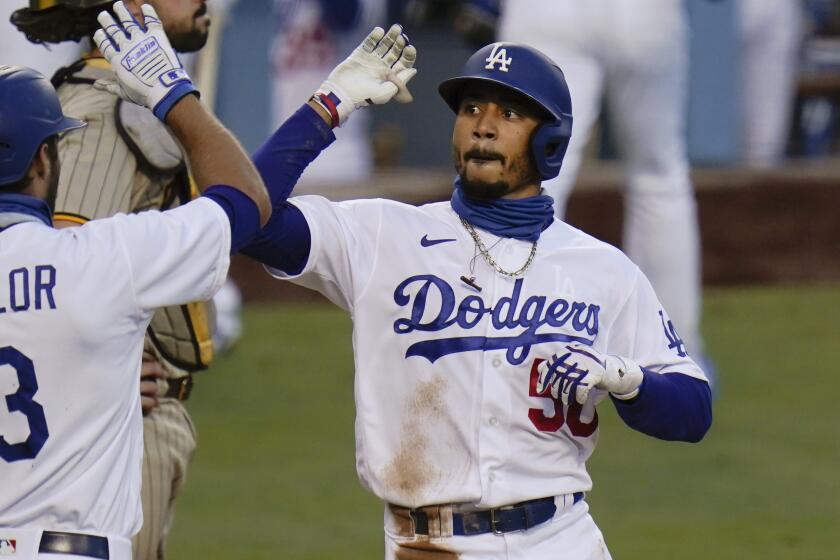 Los Angeles Dodgers' Mookie Betts, right, celebrates his two-run home run with Chris Taylor.