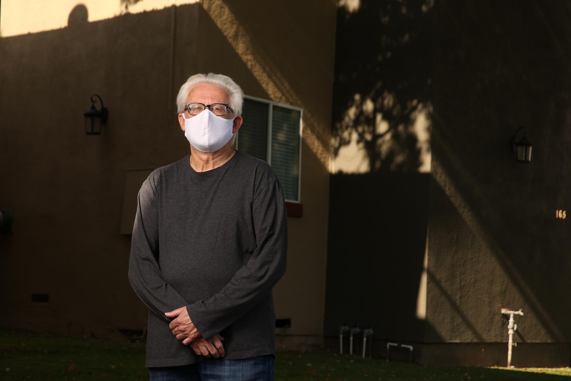 CASA volunteer Dave Stein poses for a portrait while wearing a mask