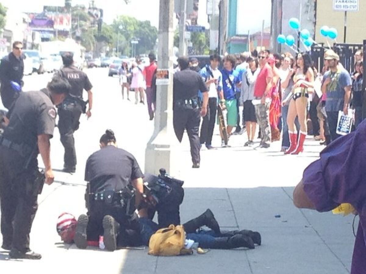 In front of Golden Apple Comics on Free Comic Book Day, LAPD officers arrest a woman they say fled the scene of a hit-and-run.