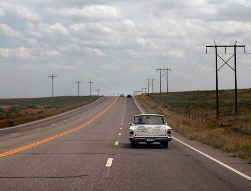 In On the Road, Kerouac wrote about visiting portions of rural America. Here, an older-model car motors through Wray, Colo., recently along the kind of open highway that Kerouac might have watched slide past his car window half a century ago.