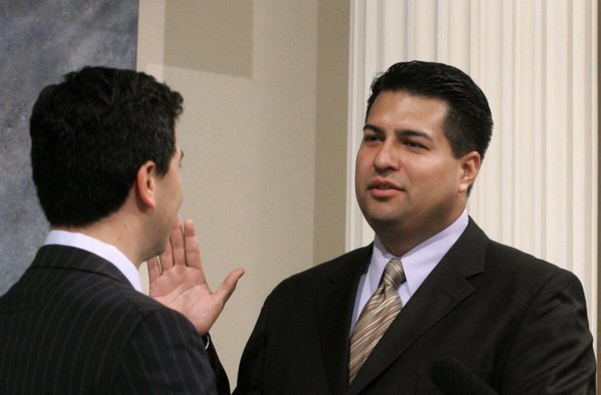 Felipe J. Fuentes III, right, is sworn in to the California Assembly in 2007. Now, while waiting to take an L.A. City Council seat to which he was elected, he is still on the Assembly payroll as a staff member to his successor.