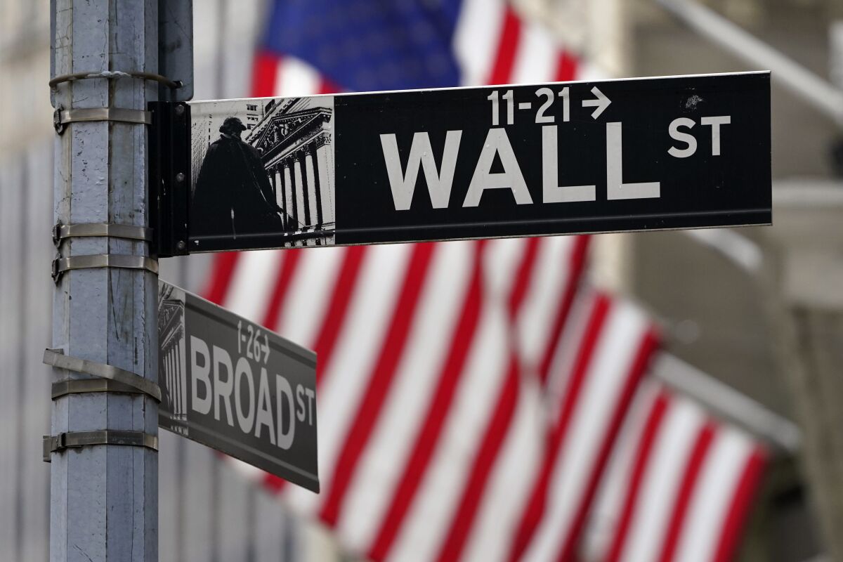 A Wall Street sign is displayed outside of the New York Stock Exchange in New York.