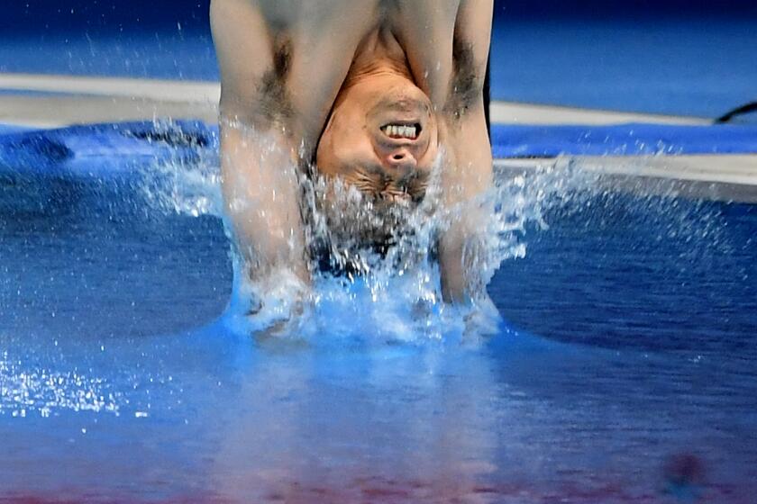 -TOKYO,JAPAN July 26, 2021: A member of Japan men's synchronized 3m springboard makes a dive in the final at the 2020 Tokyo Olympics. (Wally Skalij /Los Angeles Times)