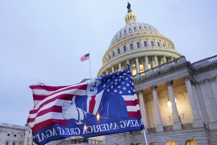 A flag depicting President Donald Trump flies in front of the Capitol on Jan. 6, 2021.