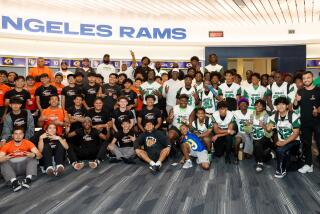 Football players from Lincoln and Dorsey high schools visit the Rams locker room at SoFi Stadium.