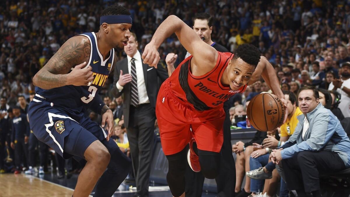 The Trail Blazers' CJ McCollum drives past the Nuggets' Torrey Craig during Game 7 of their second-round series Sunday in Denver. Portland won 100-96.