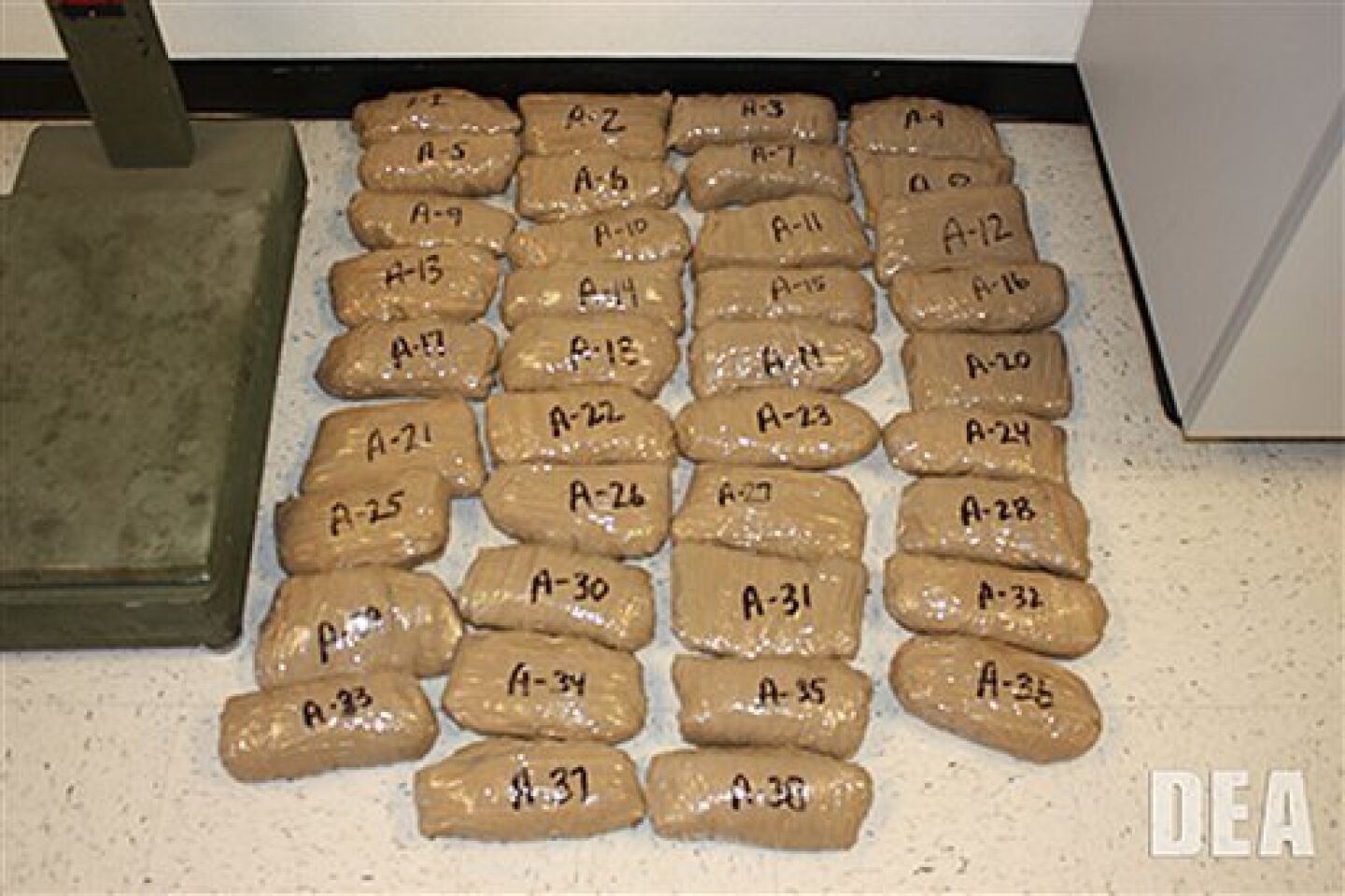 In this undated photo provided by the United States Drug Enforcement Administration, shows 39 pounds of methamphetamine smuggled through a 240-yard, complete and fully operational drug smuggling tunnel that ran from a small business in Arizona to an ice plant on the Mexico side of the border, Thurs