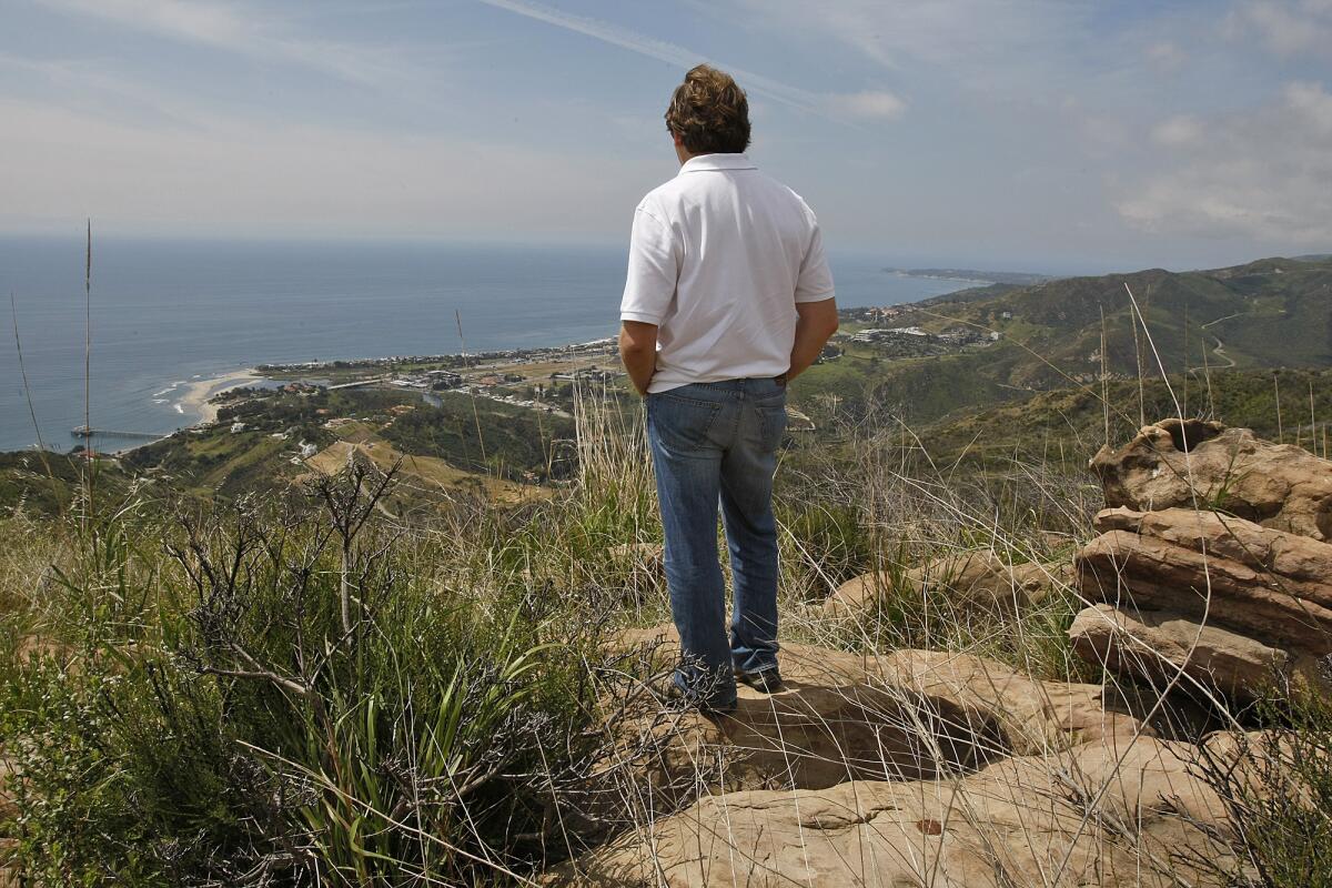 A Malibu homeowner looks at the view from the property owned by David Evans, also known as U2 guitarist the Edge.
