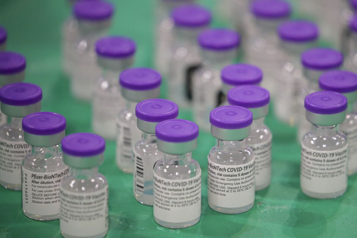 Vials of Pfizer-BioNTech COVID-19 sit on a tray at a vaccination clinic.