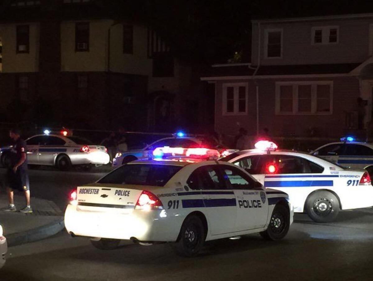In this photo provided by WHEC-TV, police vehicles block off the street after official said a fatal shooting occurred in Rochester, N.Y., Wednesday, Aug. 19, 2015. Officials have not yet released the names of the victims or the conditions of the several injured.