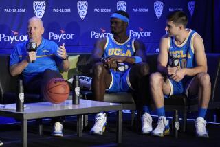UCLA head coach Mick Cronin speaks beside players Adem Bona, center, and Lazar Stefanovic.