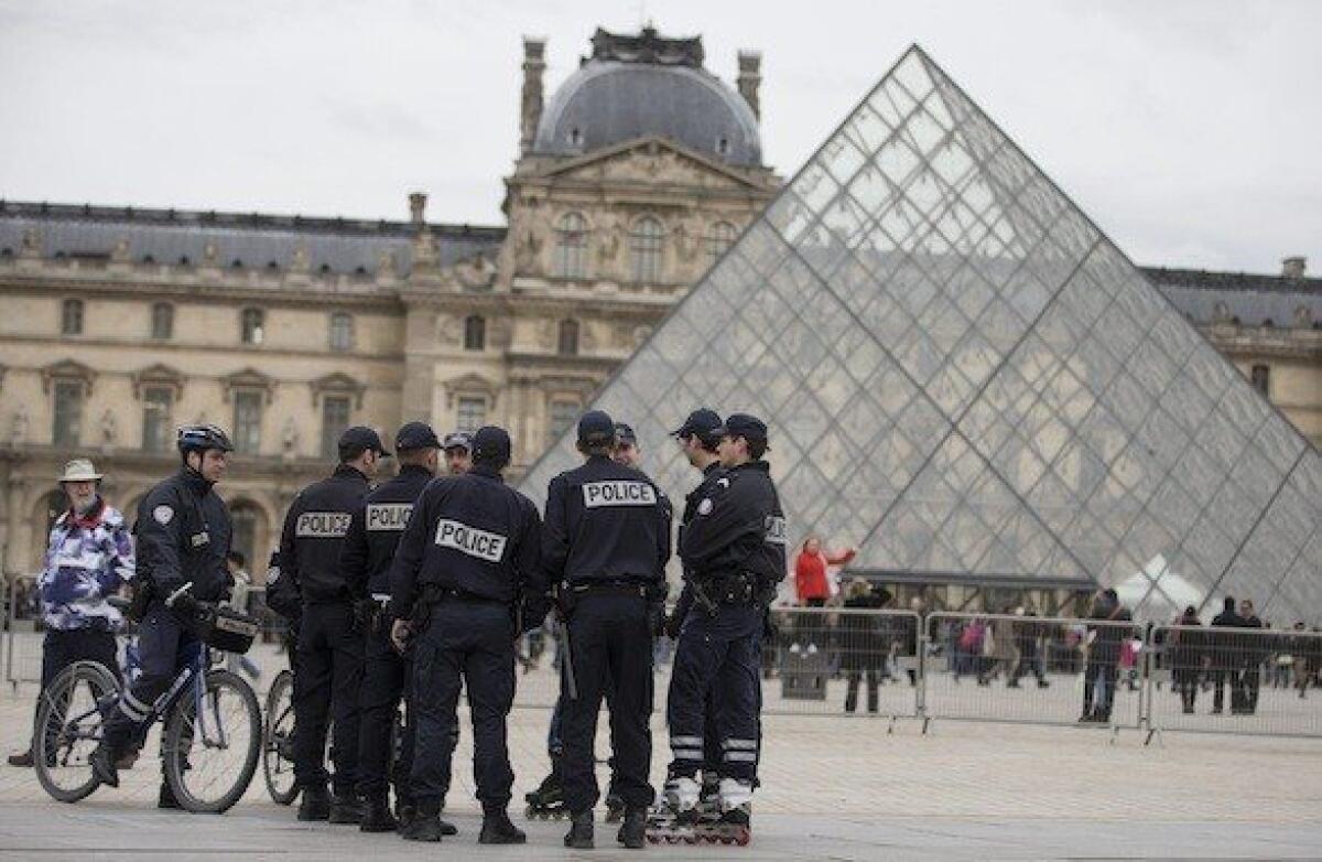 French police Thursday patrol outside the Louvre Museum in Paris, which reopened following a one-day closure. Staff walked out Wednesday to protest the rising number of pickpockets.