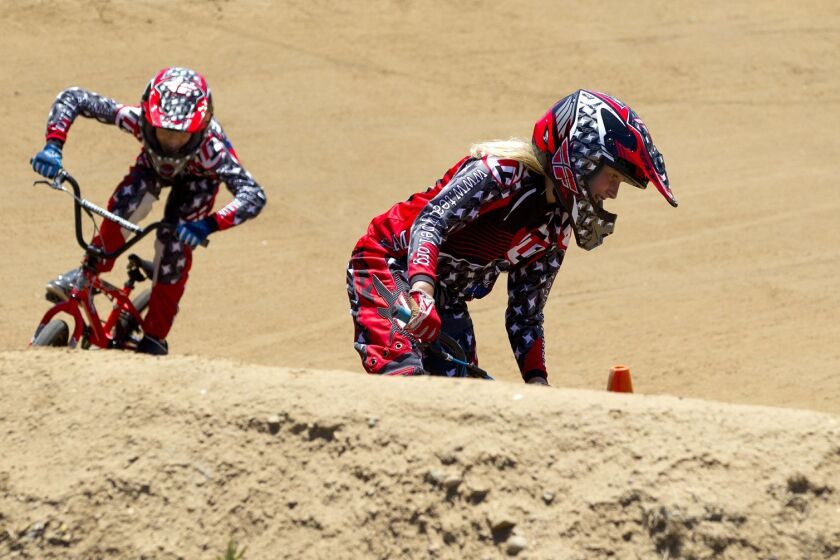 Sarah Weese (right) and Seara Fernandez (left) race with BMX Team Type 1 on the Kearny Moto BMX track as part of a charity ride to raise money for the local Juvenile Diabetes Research Foundation San Diego Chapter.