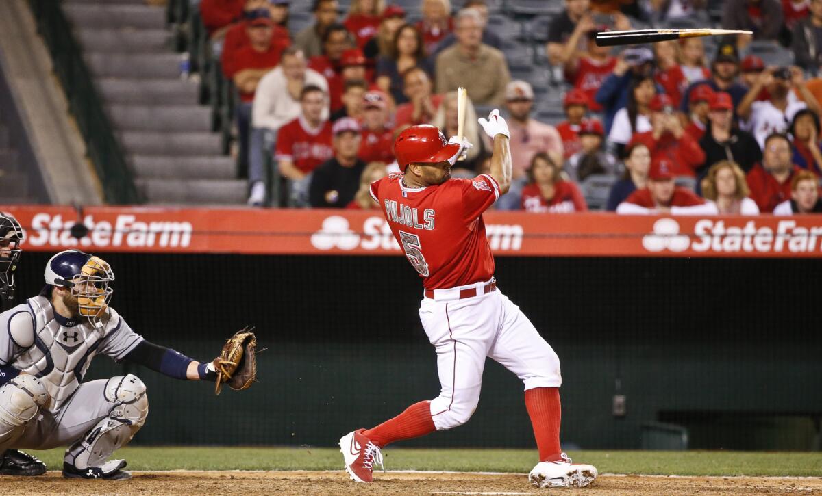 Angels first baseman Albert Pujols breaks his bat while hitting a bases loaded single to drive in the game-winning run in the ninth inning. The Angels won 4-3.