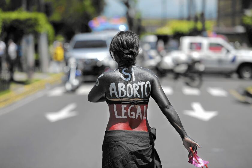 A woman participates in a march on the International Day of Action for the Decriminalization of Abortion on Sept. 28, 2012, in San Salvador.
