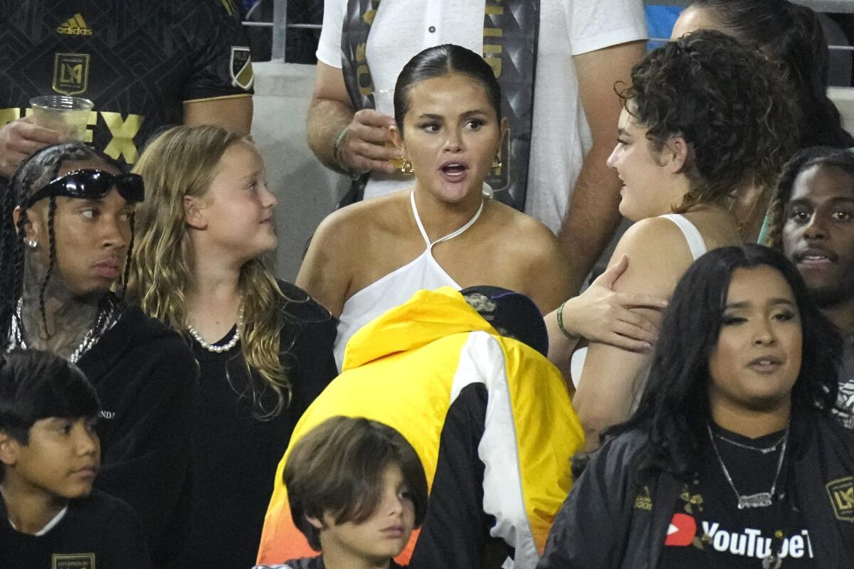  Selena Gomez, center, is seen along with rapper Tyga, left, during a Major League Soccer game