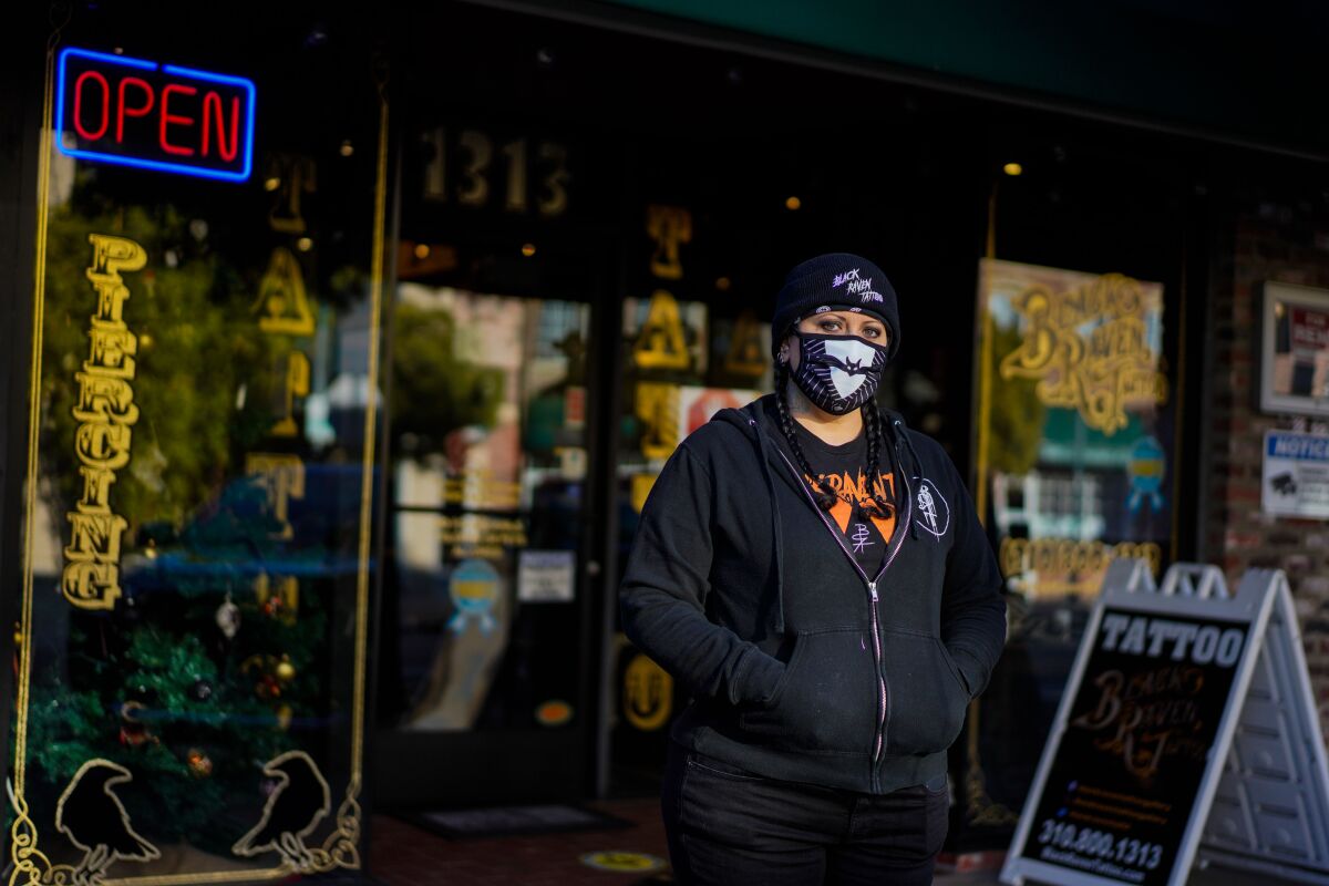 Tiffany Mitchell stands outside of her Black Raven Tattoo shop in Torrance. 