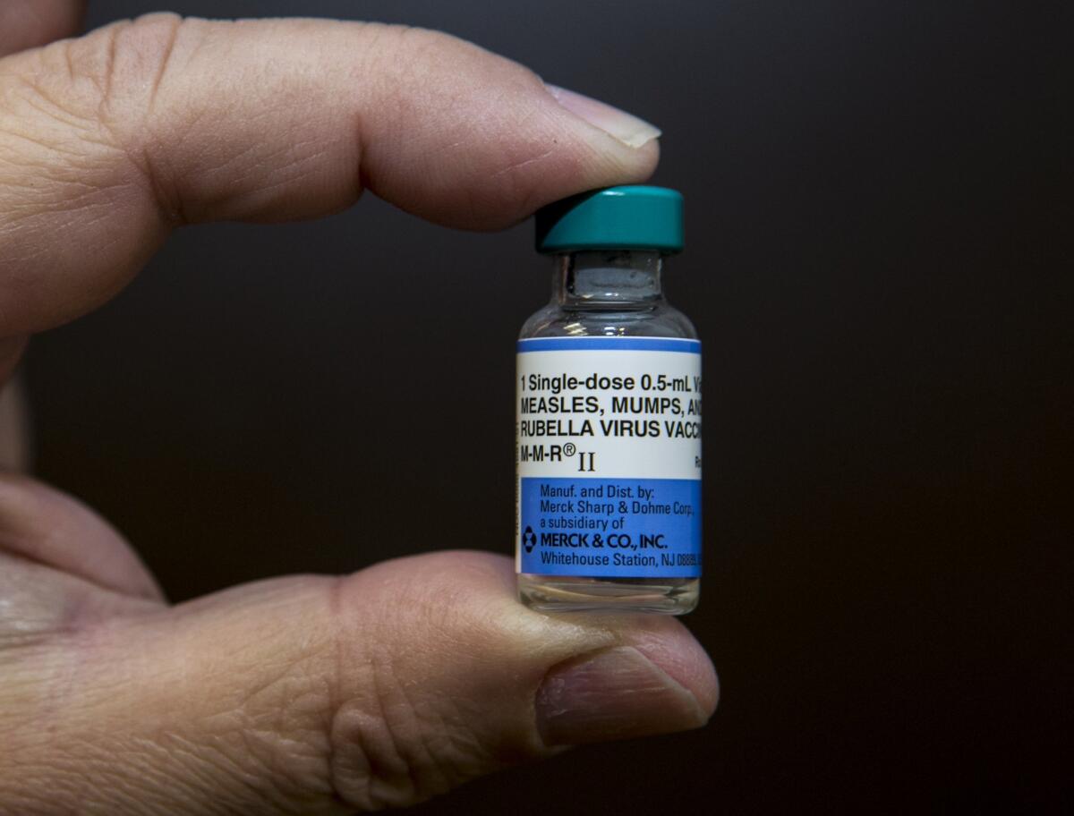 A dose of the measles-mumps-rubella, or MMR, vaccine is held by a pediatrician at his practice in Northridge. U.S. Sens. Barbara Boxer and Dianne Feinstein on Wednesday called on state officials to reconsider laws allowing parents to opt out of vaccinations for their children.