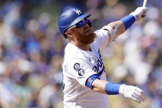 Los Angeles Dodgers' Justin Turner hits during a baseball game against the Colorado Rockies.