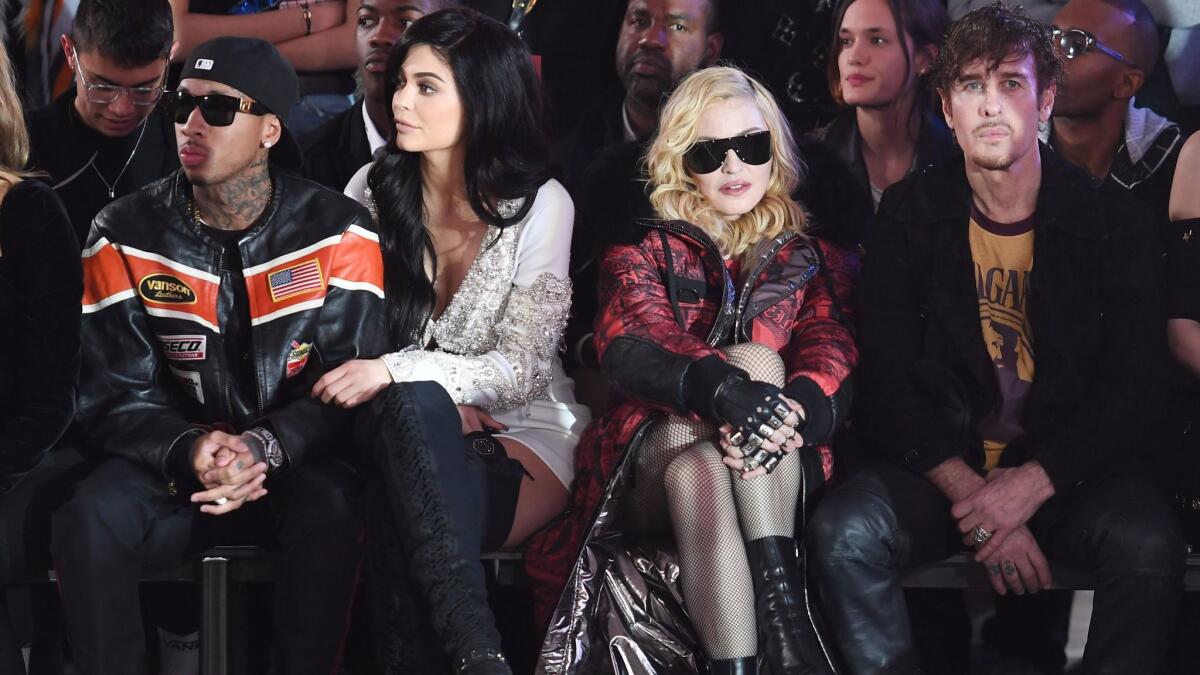 Tyga, from left, Kylie Jenner, Madonna and Steven Klein sit front row at the Philipp Plein runway show.