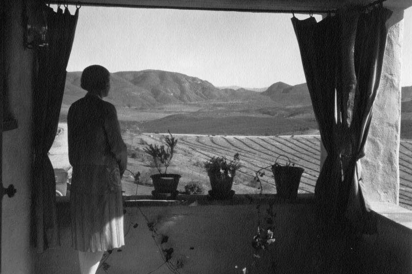 One b/w film negative. View of Lilian Rice looking from balcony across valley over Rancho Santa Fe in about 1926.