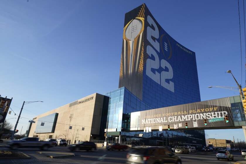 The College Football Playoff National Championship event logo is displayed on the outside of the JW Marriott, Friday, Jan. 7, 2022, in Indianapolis. Alabama and Georgia are scheduled to play in the championship game on Jan. 10 at Lucas Oil Stadium. (AP Photo/Darron Cummings)