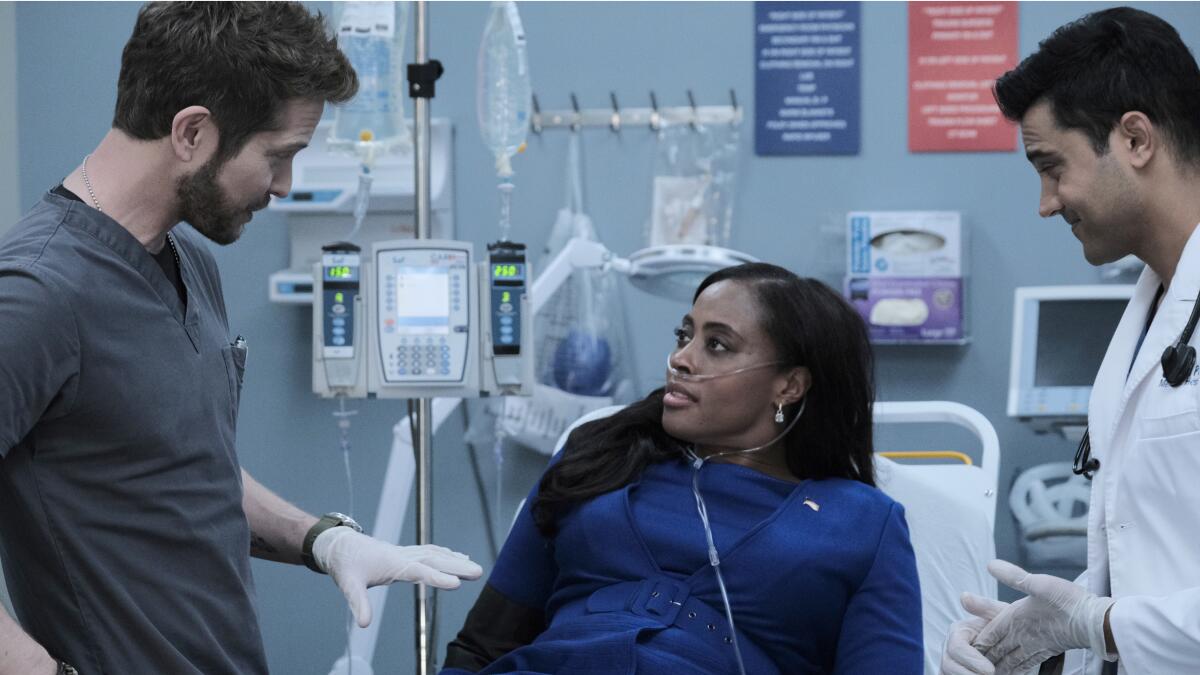 Matt Czuchry,  Nichelle Hines and Manish Dayal in a hospital setting in a scene from  "The Resident" 