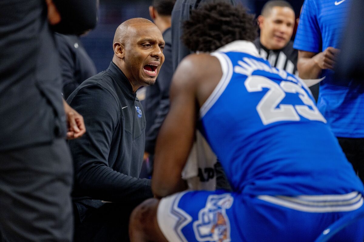 Memphis head coach Penny Hardaway instructs his team during a timeout the first half of an NCAA college basketball game against SMU in the semifinals of the American Athletic Conference tournament in Fort Worth, Texas, Saturday, March 12, 2022. (AP Photo/Gareth Patterson)