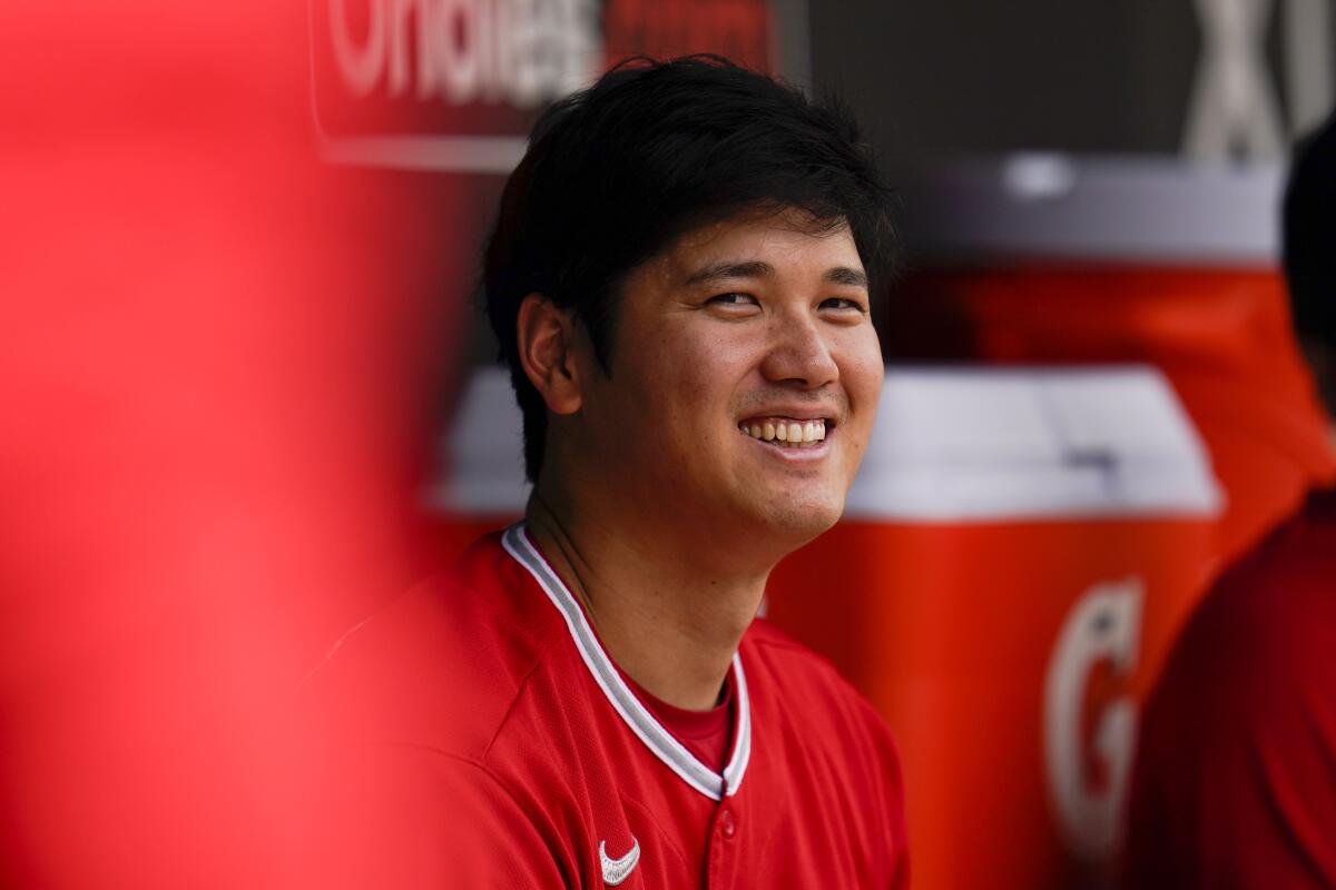Los Angeles Angels designated hitter Shohei Ohtani sits in the dugout during the fourth inning of a baseball game against the Baltimore Orioles, Sunday, July 10, 2022, in Baltimore. (AP Photo/Julio Cortez)