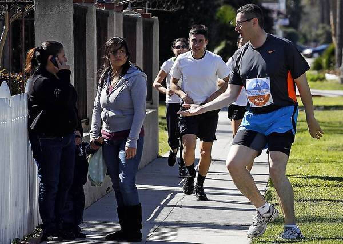 Los Angeles mayoral candidate Emanuel Pleitez greets pedestrians in the San Fernando Valley on one of his 20-mile runs to drum up votes.