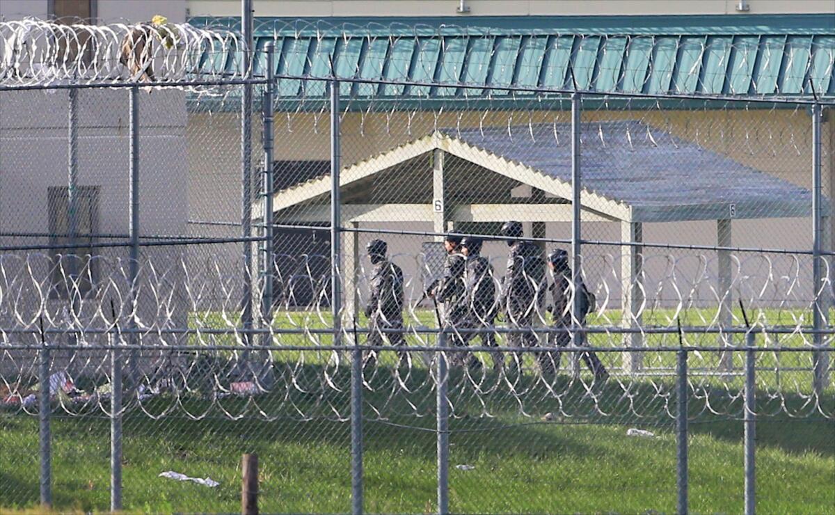 Armed personnel on Monday patrol the grounds of the Tecumseh State Correctional Institution, in Tecumseh, Neb. Inmates took control of at least part of the Tecumseh State Correctional Institution Sunday during an incident when two staff members and two inmates were injured, according to the state Department of Correctional Services.