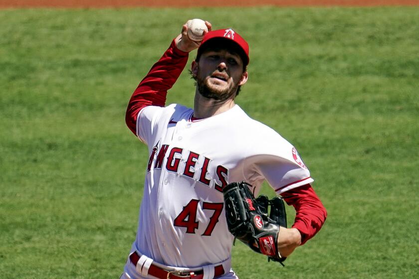 Los Angeles Angels starting pitcher Griffin Canning throws to the Seattle Mariners.