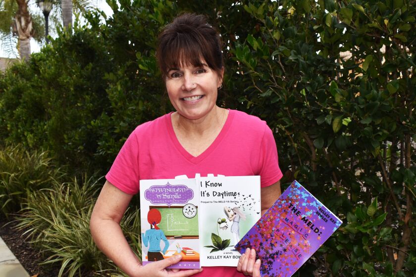 4S Ranch resident and author Kelley Gusich holding her three most recent novels.