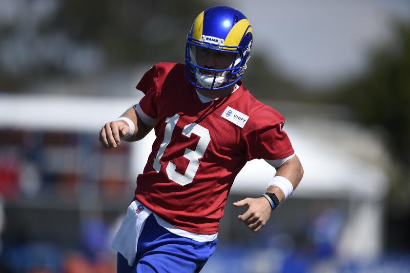 Los Angeles Rams quarterback John Wolford runs on the field during an NFL football training camp practice in Irvine, Calif., Saturday, July 31, 2021. (AP Photo/Kelvin Kuo)