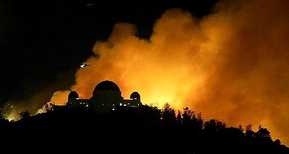 On May 8, 2007, a fire broke out in Griffith Park that took two days to contain and burned 817 acres. These are scenes from the fire that threatened some of Los Angeles' most famous landmarks and was one of the largest fires in the area in three decades. Left, nearby flames light up Griffith Observatory. About 500 fire personnel were on the scene and water was being dropped by five Los Angeles County firefighting helicopters. They were aided by two aircraft from the state.