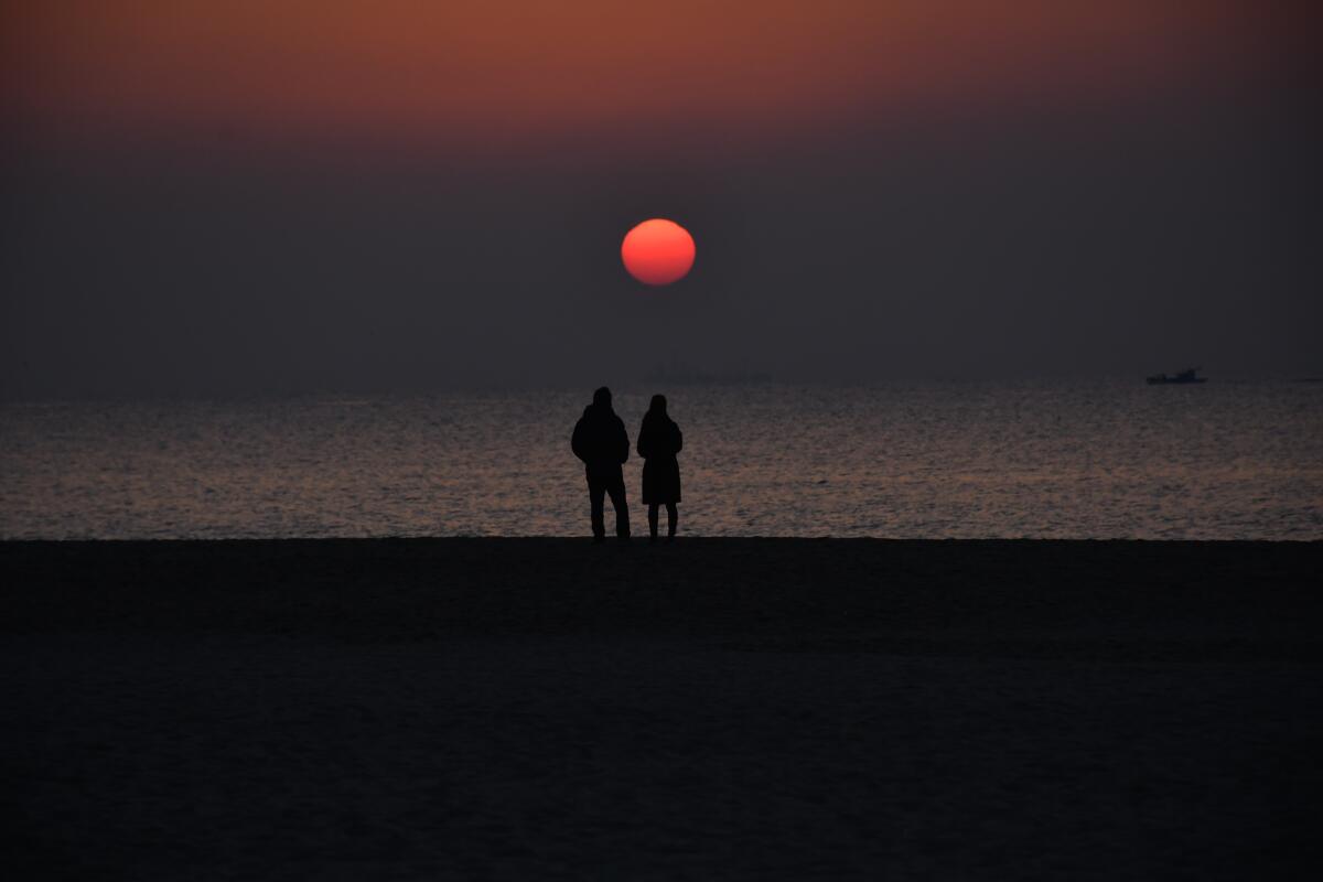 Haeundae Beach, one of the most popular spots in Busan, South Korea, is about 1 mile long, with skyscrapers rising nearby. 