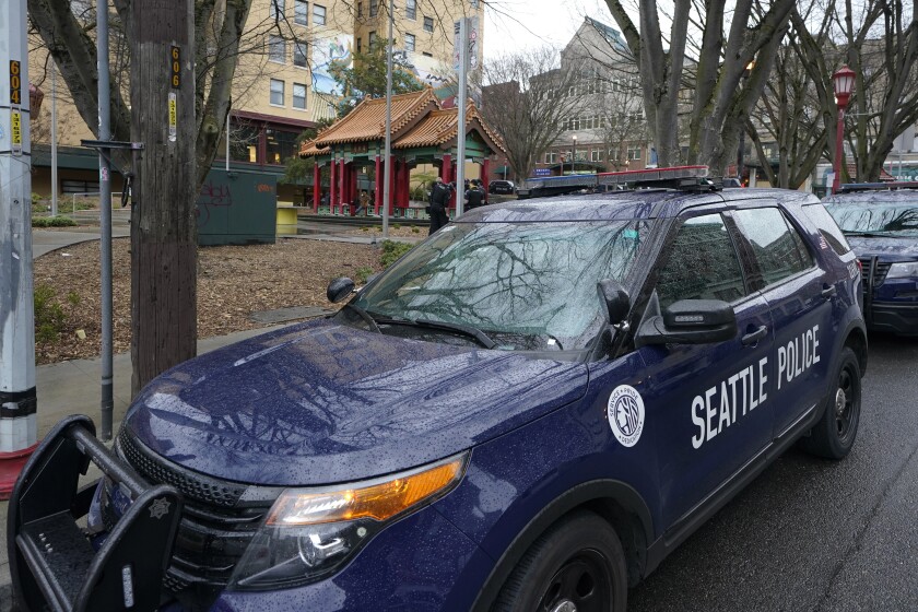 FILE - A Seattle Police vehicle sits parked at Hing Hay Park on March 18, 2021, in Seattle. Seattle's elected prosecutor is promising quicker charging decisions to help tackle persistent low-level crime that's plagued businesses downtown. City Attorney Ann Davison, a Republican who won election in November over a police and jails abolitionist, announced Monday, Feb. 7, 2022, that her office will make charging decisions on all incoming cases within five business days. (AP Photo/Ted S. Warren, File)