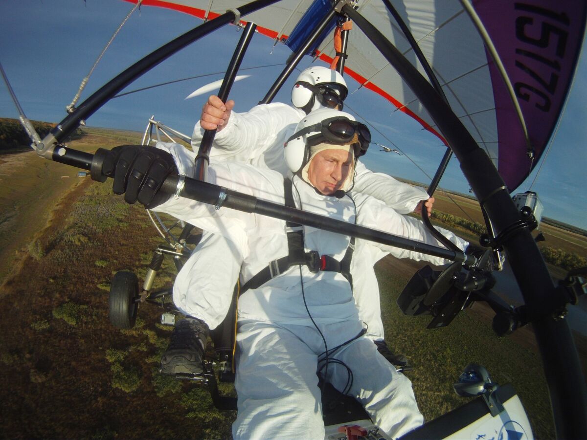 Russian President Vladimir Putin casts himself as a man of adventure and indispensable in any task. In this September 2012 file photo, he flies in a motorized hang glider to help the Siberian white crane find its route on the Yamal Peninsula. Trying to be all things to all Russians could be his undoing, says Fiona Hill, co-author of "Mr. Putin: Operative in the Kremlin."
