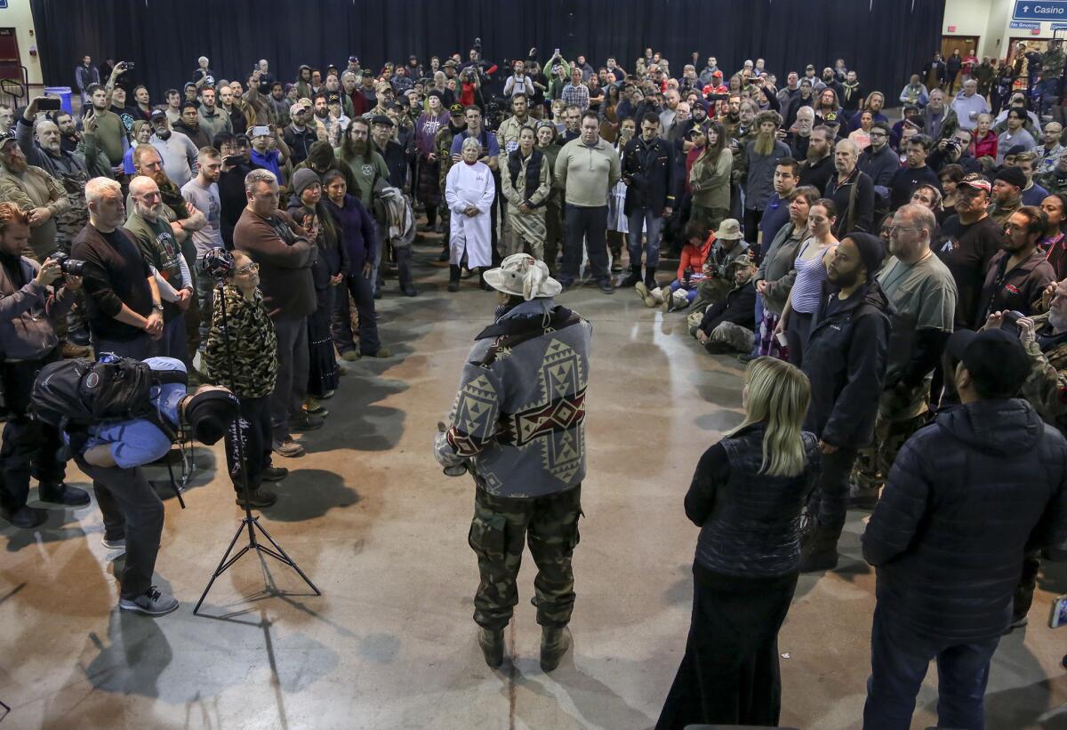 Veterans who arrived to lend support to the Standing Rock protest stand in a circle prior to a cleansing ceremony held by tribal members at the Prairie Knights Casino near Fort Yates, N.D., on Dec. 5, 2016., the morning after the U.S. Army Corps of Engineers denied an easement for the Dakota Access Pipeline to cross underneath the Missouri River near the Standing Rock Sioux Reservation.