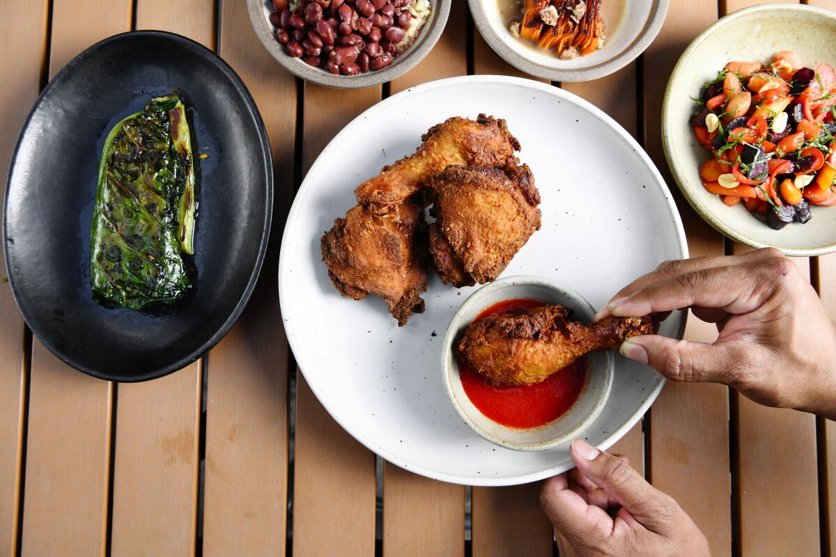 Fried chicken with collards and other side dishes at Alta Adams