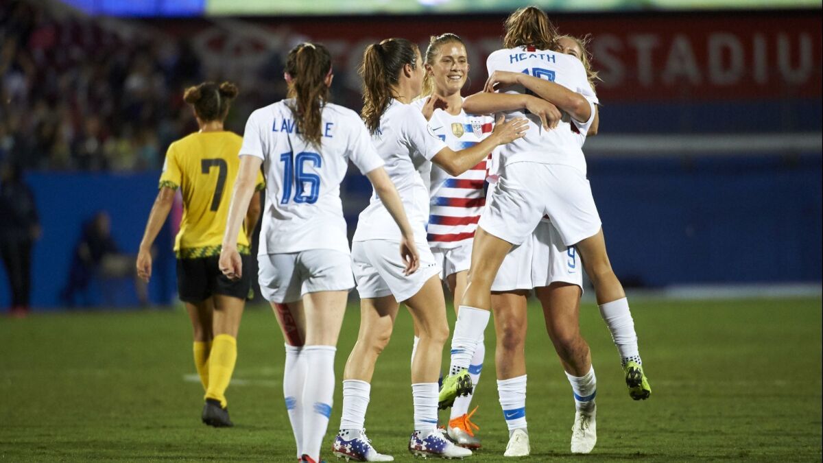 Tobin Heath (17) celebrates with U.S. teammates after scoring a goal against Jamaica during the first half of the CONCACAF Women's Championship semifinals.