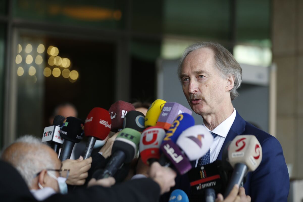 The U.N. special envoy for Syria Geir Pedersen speaks to reporters after he met with Syrian officials, including Foreign Minister Faisal Mekdad, in Damascus, Syria Wednesday, Feb. 16, 2022. Pedersen said he expects a committee representing the Syrian government and the opposition to resume talks next month over draft constitutional reforms. (AP Photo/Omar Sanadiki)