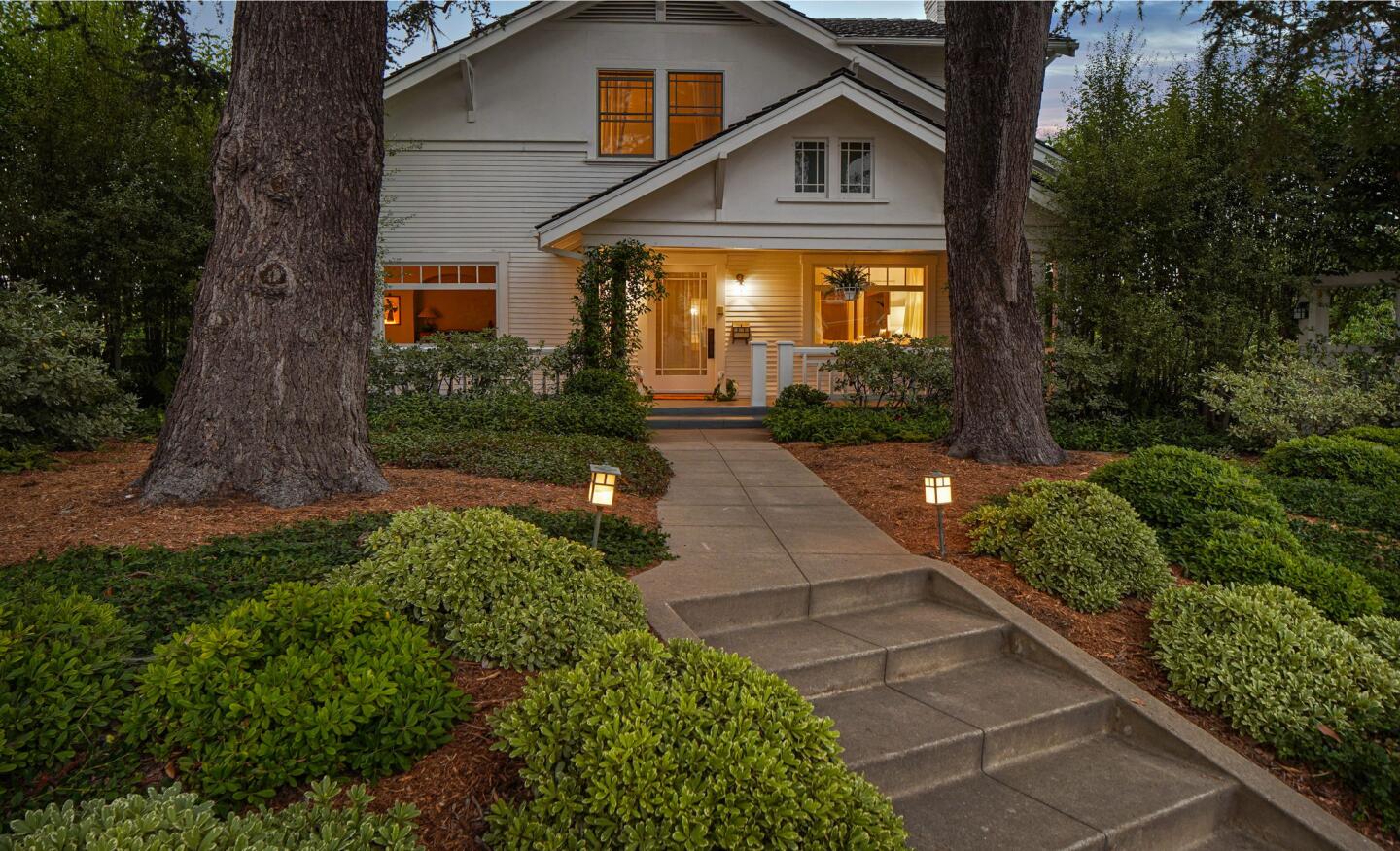 The half-acre estate includes a 99-year-old Craftsman, one-bedroom guesthouse and rustic barn surrounded by gardens and fruit trees.