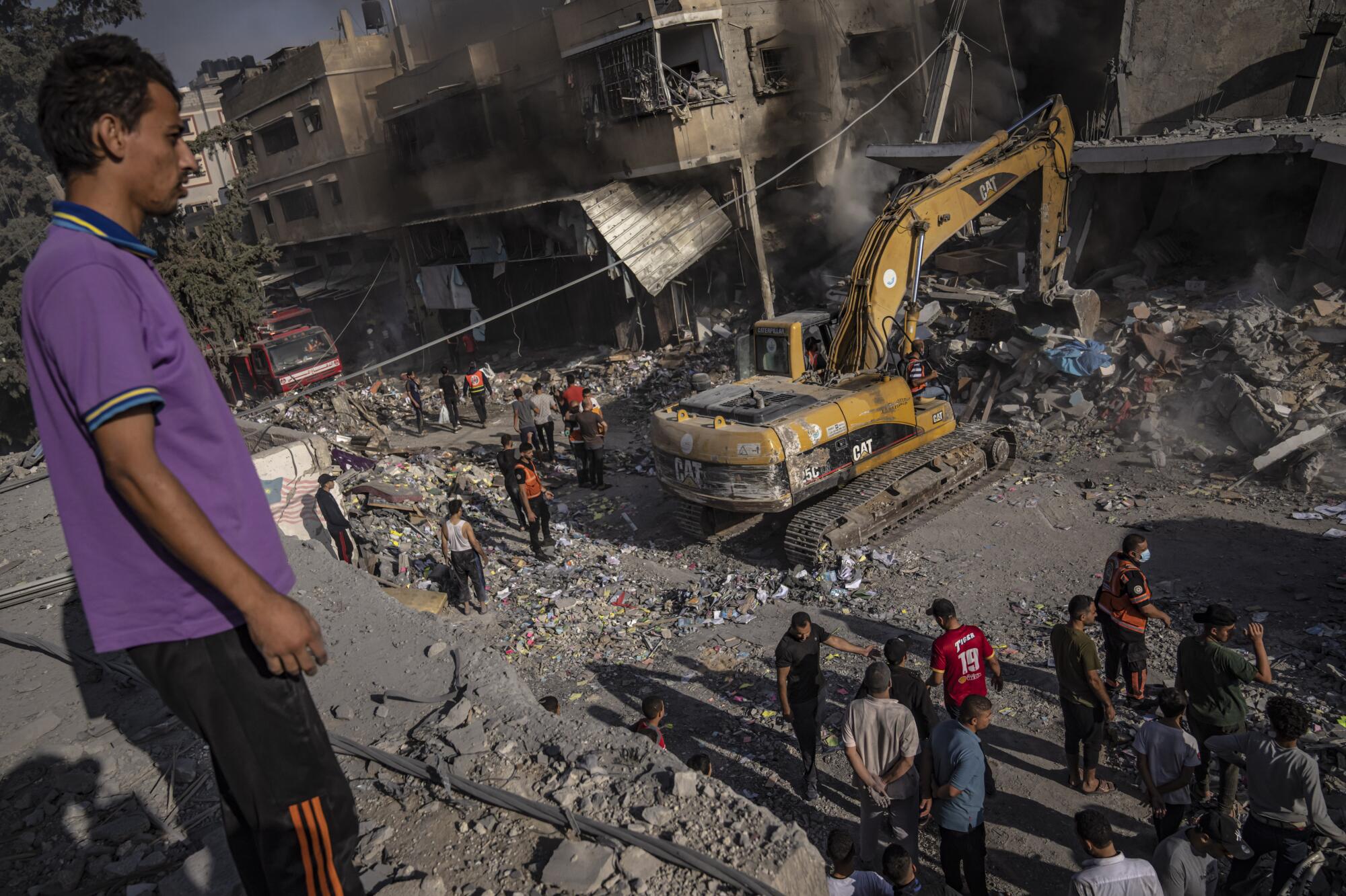 Man looking out over destruction from an Israeli airstrike on Gaza