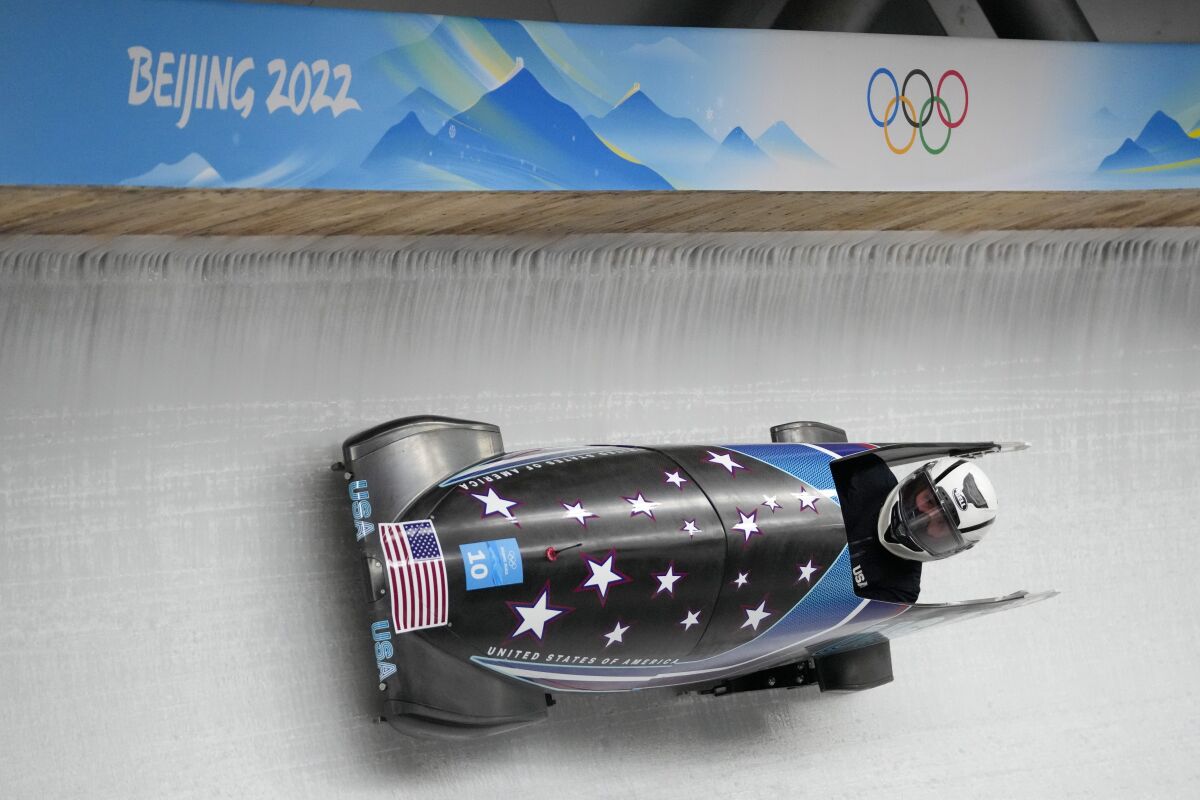 Elanta Meyers Taylor, of the United States, drives her bobsled during a women's monobob training heat at the 2022 Winter Olympics, Thursday, Feb. 10, 2022, in the Yanqing district of Beijing. (AP Photo/Mark Schiefelbein)